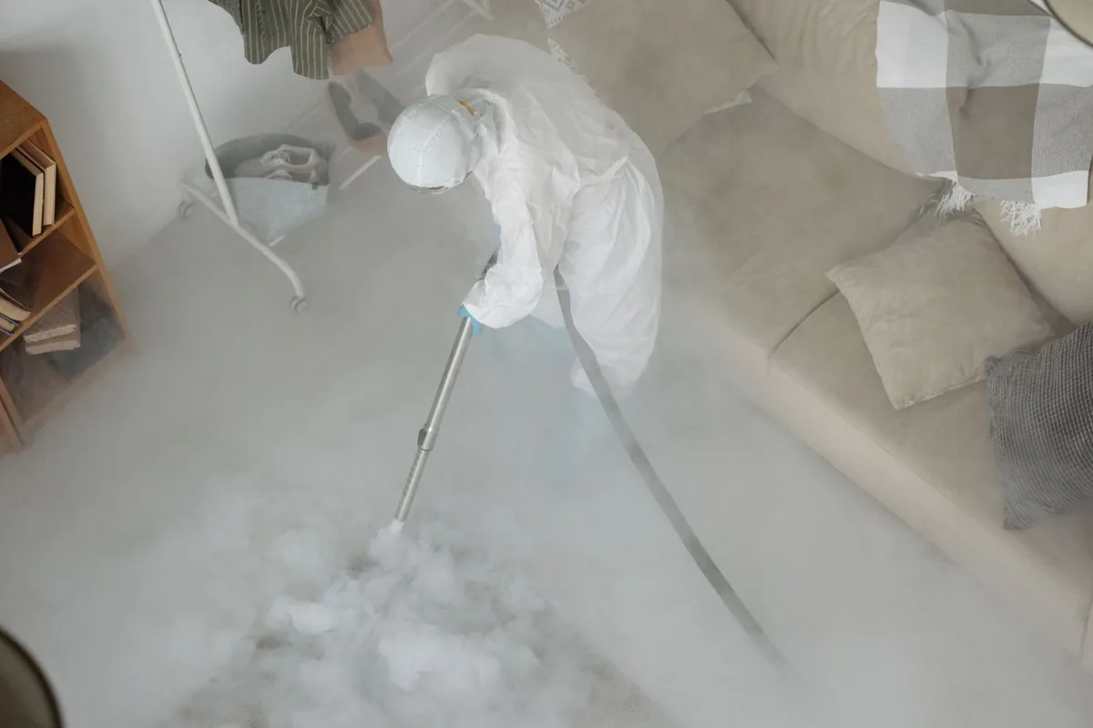Biohazard cleanup technician in protective equipment, West Glendive, MT